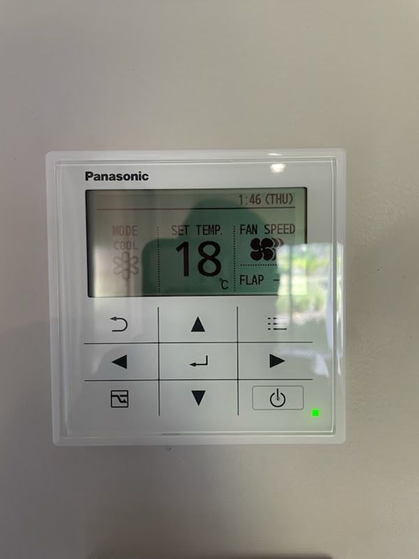 Wall controller for an air conditioning system showing 18 degrees